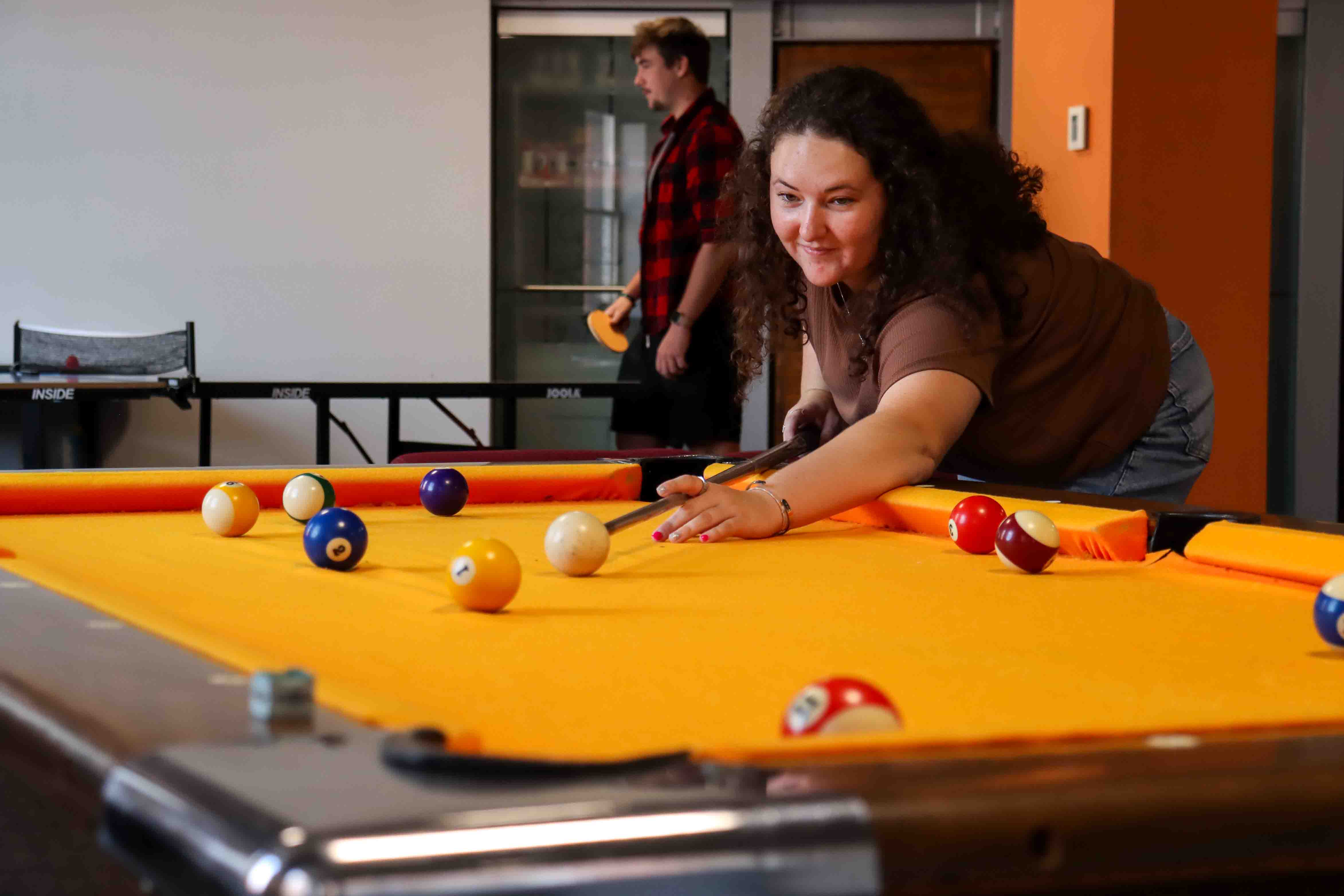 girl playing pool